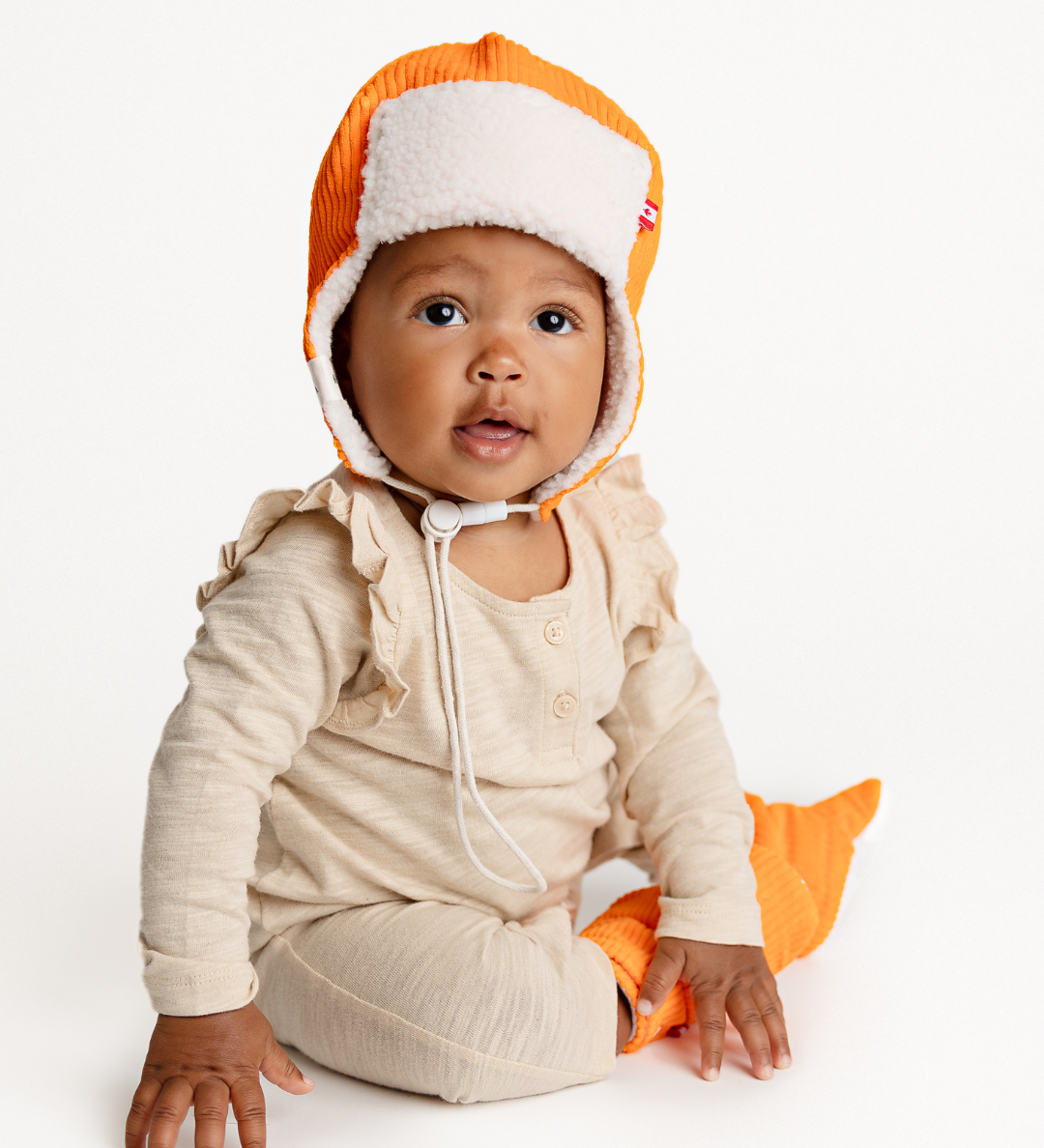 Newbornlander Bright Orange Corduroy Pilot Hat, handmade baby winter hat with cream sherpa ear flaps, front view