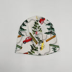 Newbornlander Canadian Trip beanie hat for babies, cream cotton with watercolour cars, pine trees and road signs, front view